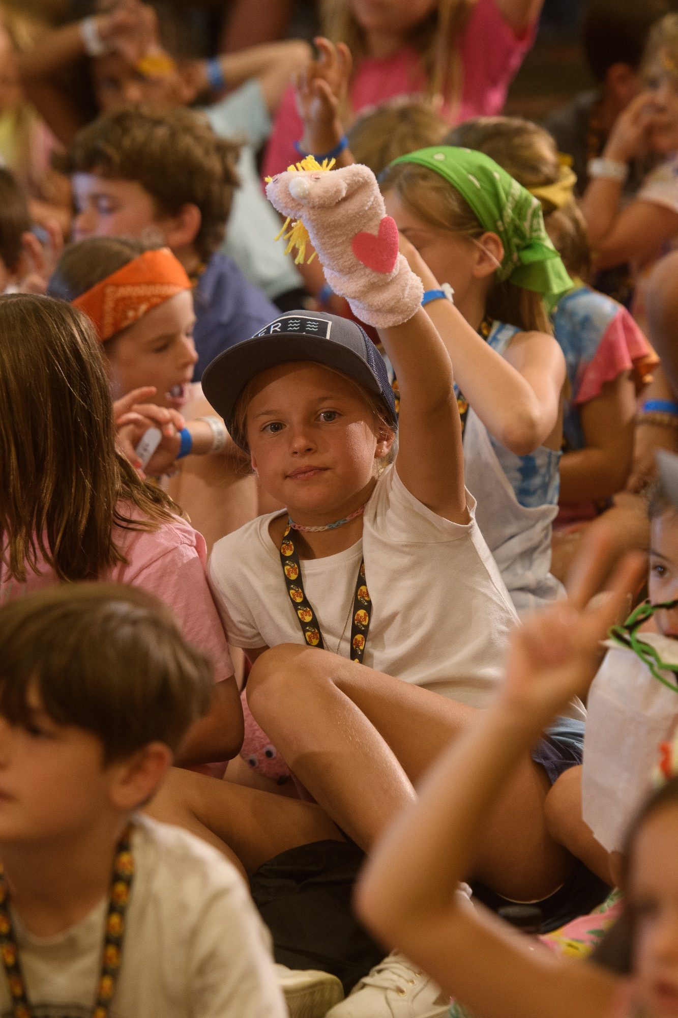 A child holding up a handmade sock puppet during the program
